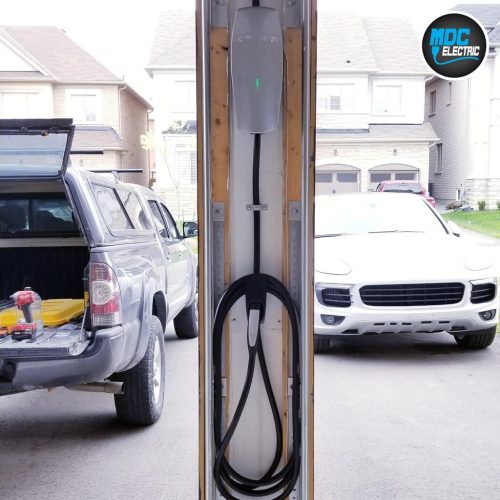 Tesla charger between garage doors by MDC Electric