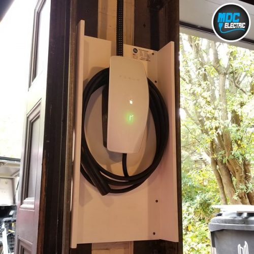 Tesla Wall Connector between garage doors by MDC Electric